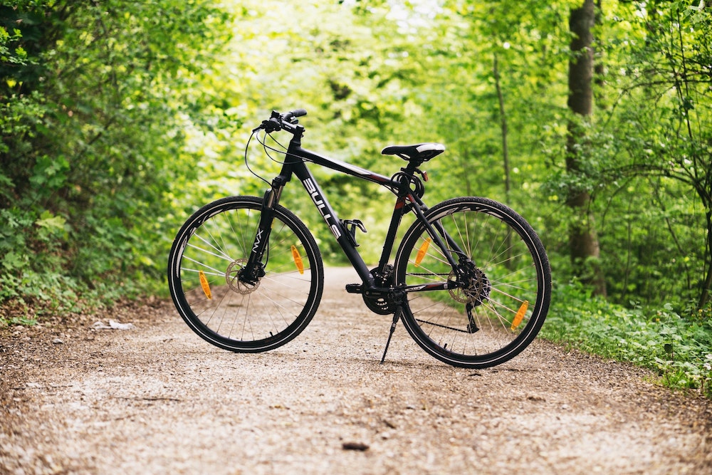 Black bike on a path through the forest